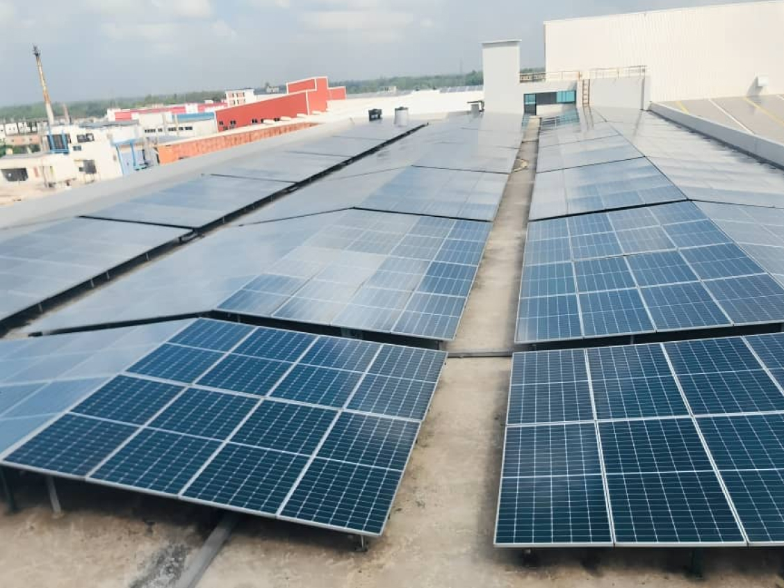 Solar rooftop panels installed above a textile manufacturing unit replace with your Yogeshwar Fabrics / Autotech Motors project photo