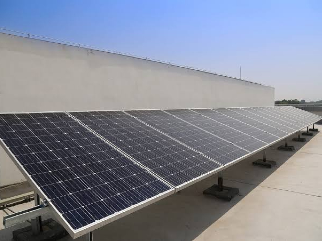 Warehouse and logistics facility rooftop covered with solar panels - replace with your project photo